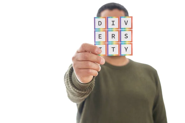 Unrecognizable mature man holds the word diversity with the colors of the LGBTQ movement on white background. Concept of tolerance, inclusion and diversity. —  Fotos de Stock