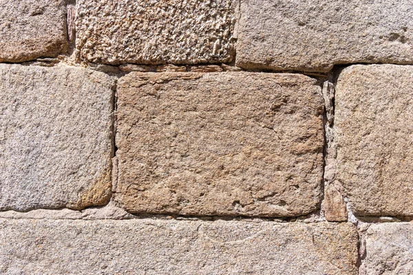 Close-up of an old wall of large stone bricks forming an excellent decorative background. High quality photo