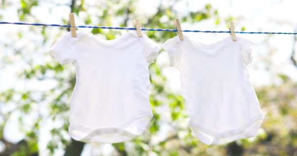 White Baby Clothes Hanging Rope Outdoors Spring Day — Video