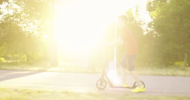 Дитина Скутером Молодий Хлопчик Їде Скутері Дорозі Парк Влітку Діти — стокове відео
