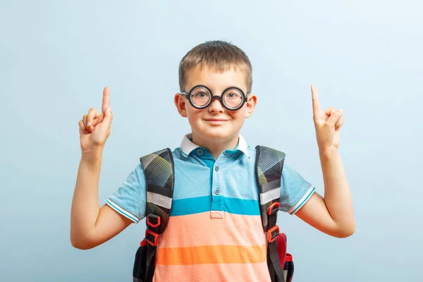 Happy School Boy Pointing Fingers Showing Something Blue Background Studio — 图库照片