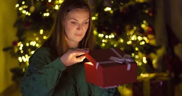 Schöne Junge Frau Öffnet Weihnachtsgeschenkschachtel Mit Aufgeregtem Überraschtem Gesicht Und — Stockvideo