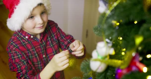 Cute Boy Santa Hat Decorating Christmas Tree New Year Celebrations — Stok video