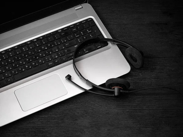 Szary Laptop Słuchawki Mikrofonem Czarnej Drewnianej Powierzchni Koncepcja Kształcenia Odległość — Zdjęcie stockowe