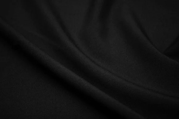 黒の生地の質感を閉じます キーの低い写真 プラスの糸 衣類産業 抽象的な背景 黒い織物の波 黒布の背景 ロイヤリティフリーのストック写真