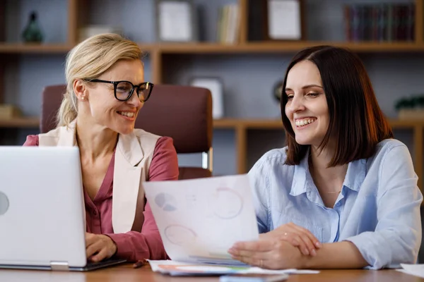 Two Businesswomen Discussing Financial Report Holding Documents Graphs Charts Communicate — Stockfoto