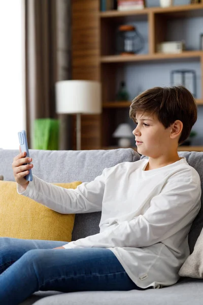 Portrait Young Cute Boy Holding Smartphone Sitting Sofa Teenager Home —  Fotos de Stock