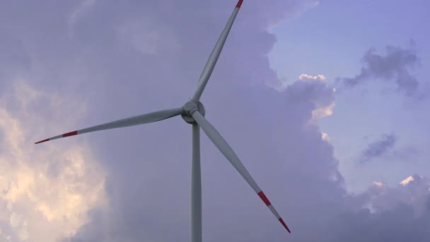 Tir à la main. Une éolienne avec un ciel nuageux bleu en arrière-plan. Investissements dans l'énergie verte. Concept d'électricité verte — Video