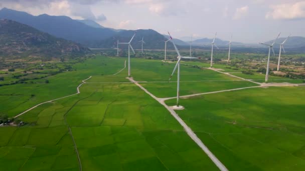 Aerial shot. A big green filed with lots of wind power plants. Investments in green energy. Green electricity concept — Stock Video