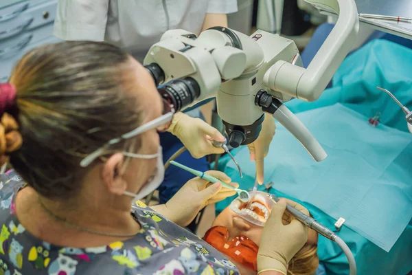 Tandheelkundige behandeling met een microscoop. Een vrouw die tanden laat onderzoeken bij tandartsen. Afspraak bij de tandarts. lifestyle, het echte leven — Stockfoto