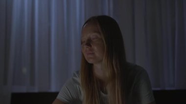 Geceleri bir kadın uyumadan önce dinlenmek için meditasyon ve rahatlama uygulaması yapar. Stres önleyici uygulamalar. Sağlıklı bir yaşam tarzı. Yeni normal