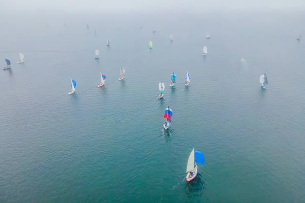 Aerial birds eye view photo taken by drone of sailboat in turquoise sea water — Stock Photo, Image