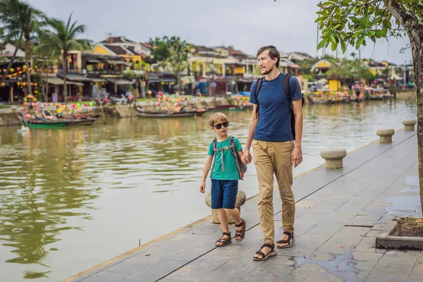 Viajeros de padre e hijo en el fondo de Hoi An ciudad antigua, Vietnam. Vietnam se abre de nuevo a los turistas después de la cuarentena Coronovirus COVID 19 — Foto de Stock