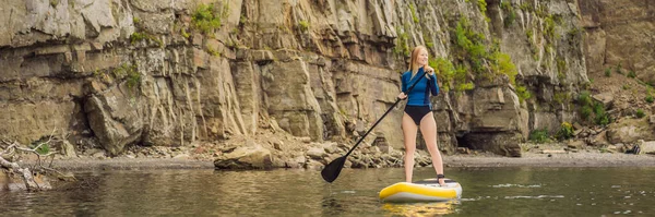BANNER, LONG FORMAT Young women Having Fun Stand Up Paddling in the sea. SUP. Red hair girl Training on Paddle Board near the rocks — Stock Photo, Image