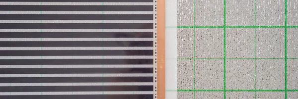 Рулон плівкового підігріву підлоги лежить на ізоляції BANNER, LONG FORMAT — стокове фото