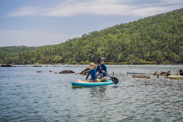 Happy family of two, mother and son, enjoying stand up paddling during summer vacation — Stock Photo, Image