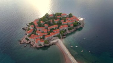 Hava görüntüsü. Sveti Stefan adasının yavaş çekim videosu. Budva şehrinin yakınlarında ünlü bir turistik mekan. Karadağ 'a Seyahat