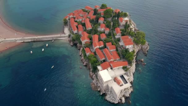 Aerial shot. Slowmotion video of the Sveti Stefan island. Famous tourist location near the city of Budva. Travel to Montenegro concept — Stock Video