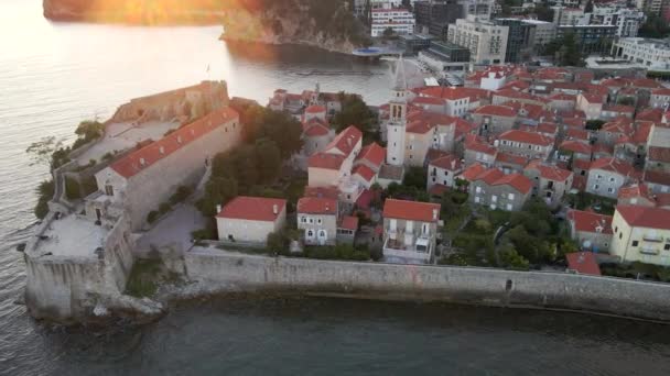 Aerial video. Slowmotion shot. The Old Town of the city of Budva popular tourist destination in Montenegro. Sunset time. — Stock Video