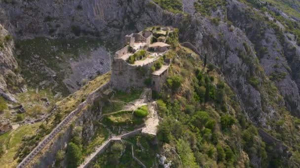 Foto aérea de la fortaleza San Juan San Giovanni sobre el casco antiguo de Kotor, el famoso lugar turístico de Montenegro. — Vídeos de Stock