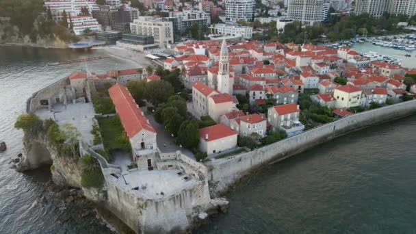 Aerial video. Slowmotion shot. The Old Town of the city of Budva popular tourist destination in Montenegro. Sunset time. — Stock Video