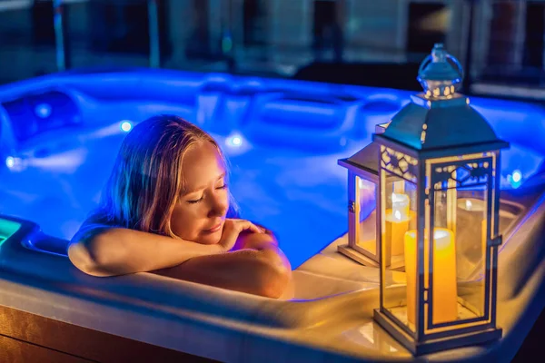 Portrait of young carefree happy smiling woman relaxing at hot tub at night during enjoying happy traveling moment vacation. Life against the background of green big mountains — Foto de Stock