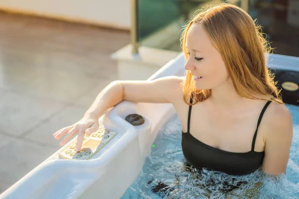 Portrait of young carefree happy smiling woman relaxing at hot tub during enjoying happy traveling moment vacation life against the background of green big mountains — Stockfoto
