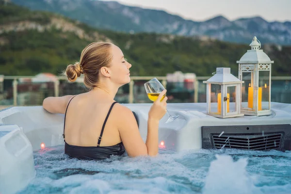 Retrato de la joven despreocupada feliz mujer sonriente relajarse en la bañera de hidromasaje durante el disfrute de la vida feliz viaje momento de vacaciones en el fondo de grandes montañas verdes — Foto de Stock