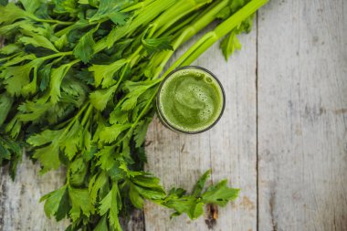 Celery Juice, Healthy Drink, bunch of celery on a wooden background
