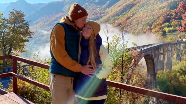 两名妇女和一名男子参观了黑山北部塔拉河峡谷上宏伟的Djurdjevica桥。在秋天拍的。前往东欧的旅行概念 — 图库视频影像
