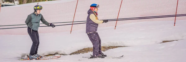 Kvinnan lär sig åka skidor med instruktören. Vintersport. Skidlektion i alpin skola BANNER, LONG FORMAT — Stockfoto