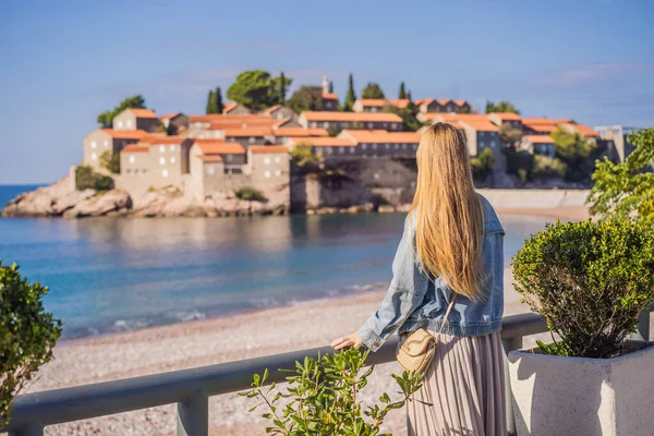 Mulher turista no fundo da bela vista da ilha de Santo Estêvão, Sveti Stefan no Budva Riviera, Budva, Montenegro. Viajar para Montenegro conceito — Fotografia de Stock