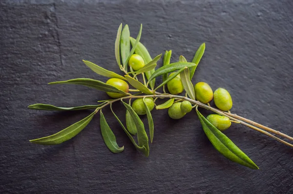 Green and black olives with leaves on dark background. Copy space, flat lay — Stock Photo, Image