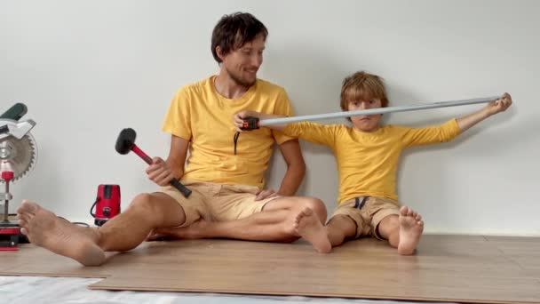 Otec a jeho syn postavili laminát na podlahu ve svém bytě. Koncept DIY. Zpomalení videa