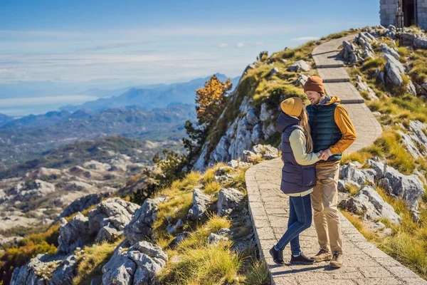 Couple man and woman tourists in mountain landscape at national park Lovcen, Montenegro. Travel to Montenegro concept — Stock Photo, Image