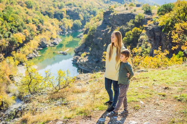 Montenegro. Mom and son tourists on the background of Clean clear turquoise water of river Moraca in green moraca canyon nature landscape. Travel around Montenegro concept — Stock fotografie