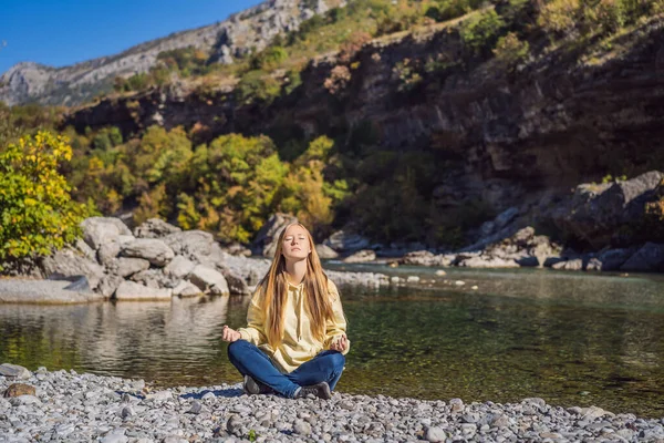 Montenegro. Woman tourist meditates on the background of Clean clear turquoise water of river Moraca in green moraca canyon nature landscape. Travel around Montenegro concept — 스톡 사진