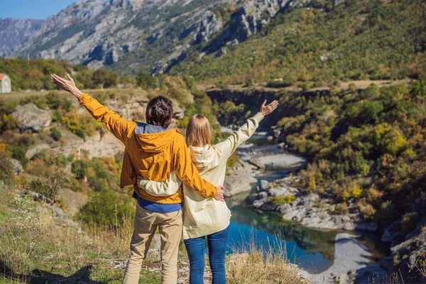 Montenegro. Happy couple man and woman tourists on the background of Clean clear turquoise water of river Moraca in green moraca canyon nature landscape. Travel around Montenegro concept — 스톡 사진