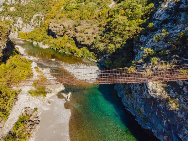 Sights of Montenegro. Landmark Old rusty bridge. Attraction Long extreme suspension iron bridge across the river Moraca. Montenegro — Fotografia de Stock