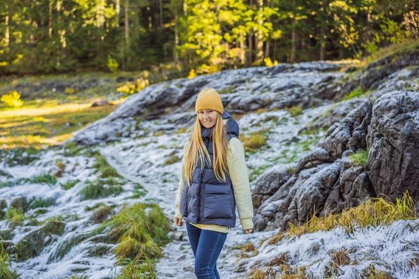 Young adult woman alone slowly walking after snowfall. Peaceful atmosphere in amazing awesome winter day. Enjoying fresh air in snowy forest trail — Fotografia de Stock