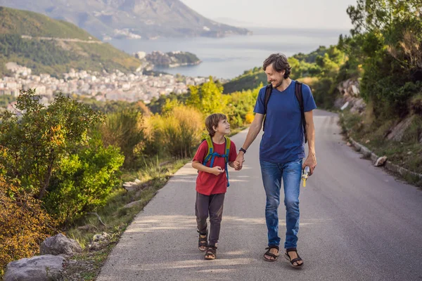 Happy family on the background of Panoramic view of the city of Budva, Montenegro. Beautiful view from the mountains to the Adriatic Sea — Fotografia de Stock