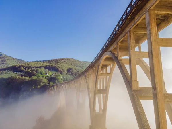 Montenegro. Dzhurdzhevich Bridge Over The River Tara foggy morning in Summer — Fotografia de Stock