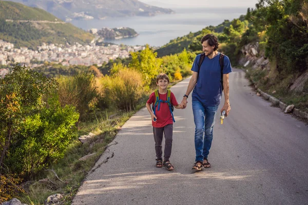 Happy family on the background of Panoramic view of the city of Budva, Montenegro. Beautiful view from the mountains to the Adriatic Sea — Fotografia de Stock