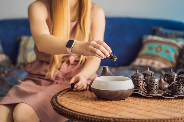 Woman Adding Essential Oil Aroma Diffuser Table — Stock Photo, Image
