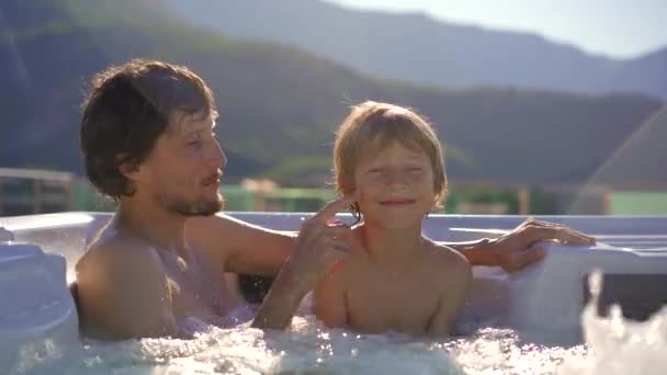 Young Man His Son Relaxing Hot Tub Rooftop View Mountains — Stock Video