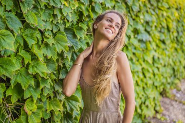 Karadağ 'da yürüyen bir kadın turist. Karadağ 'ın Adriyatik Denizi kıyısındaki güzel yeşil Kraliyet Parkı Milocer' in panoramik yaz manzarası.