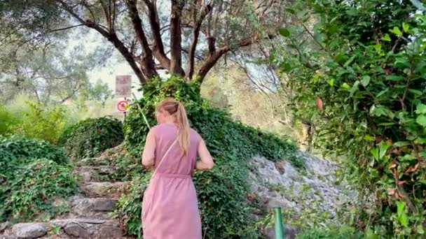 一位妇女和她的儿子参观了著名的旅游胜地 老橄榄塔 据说它有2000年的历史了 前往黑山的旅行概念 — 图库视频影像