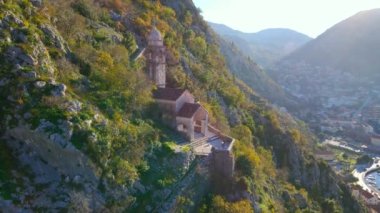 Aerial shot of the Christian church on a way to the top of the mountain where st. Johns fort is located. Crkva Gospe od Zdravlja, church of St. Mary of Health in Kotor. Travel to Montenegro concept.