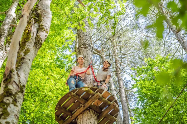 Two Women Girls Female Gliding Climbing Extreme Road Trolley Zipline — 스톡 사진