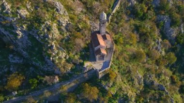Aerial shot of the Christian church on a way to the top of the mountain where st. Johns fort is located. Crkva Gospe od Zdravlja, church of St. Mary of Health in Kotor. Travel to Montenegro concept.